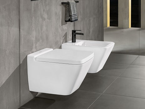 White Wall Hung Toilet and Bidet in Grey Tiled Bathroom